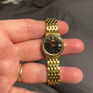 Citizen watch Gold tone with black face. Date with three hands